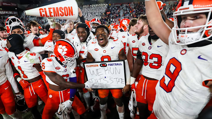 Nov 25, 2023; Columbia, South Carolina, USA; Clemson Tigers linebacker Barrett Carter (0) holds a  We Run this state  sign after defeating the South Carolina Gamecocks at Williams-Brice Stadium. Mandatory Credit: Jeff Blake-Imagn Images