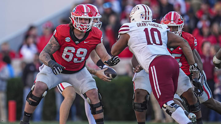 Nov 23, 2024; Athens, Georgia, USA; Georgia Bulldogs offensive lineman Tate Ratledge (69) blocks against Massachusetts Minutemen defensive end Zukudo Igwenagu (10) during the second half at Sanford Stadium. Mandatory Credit: Dale Zanine-Imagn Images
