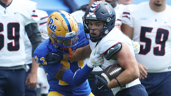Aug 30, 2025; Pittsburgh, Pennsylvania, USA; Duquesne Dukes wide receiver Joey Isabella (5) runs after a catch against Pittsburgh Panthers defensive back Davion Pritchard (23) during the third quarter at Acrisure Stadium. Mandatory Credit: Charles LeClaire-Imagn Images