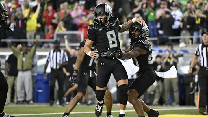 Oct 12, 2024; Eugene, Oregon, USA; Oregon Ducks quarterback Dillon Gabriel (8) celebrates with running back Jordan James (20) after scoring a touchdown during the second half against the Ohio State Buckeyes at Autzen Stadium. Mandatory Credit: Troy Wayrynen-Imagn Images