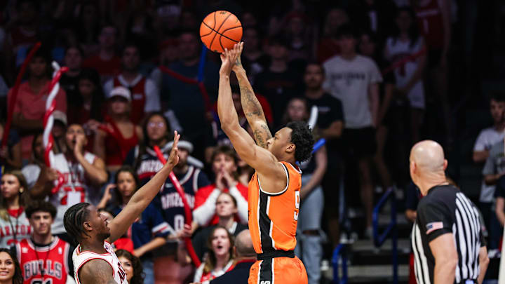 Feb 7, 2026; Tucson, Arizona, USA; Oklahoma State Cowboys guard Anthony Roy makes a three pointer over Arizona Wildcats guard Jaden Bradley (0) during the second half of the game at McKale Memorial Center. Mandatory Credit: Aryanna Frank-Imagn Images