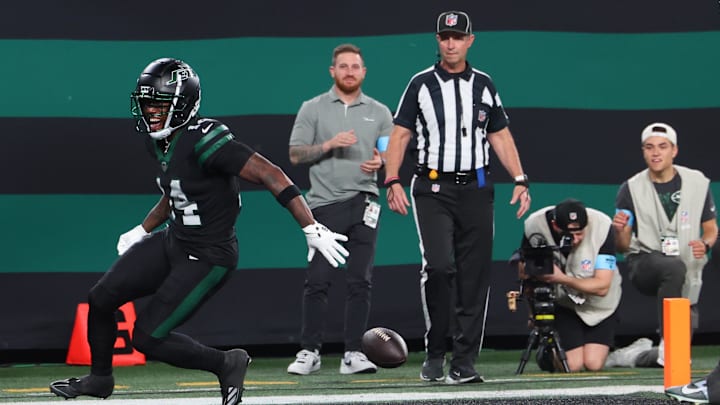 Oct 31, 2024; East Rutherford, New Jersey, USA; New York Jets wide receiver Malachi Corley (14) drops the ball prior to crossing the goal line against the Houston Texans during the first half at MetLife Stadium.