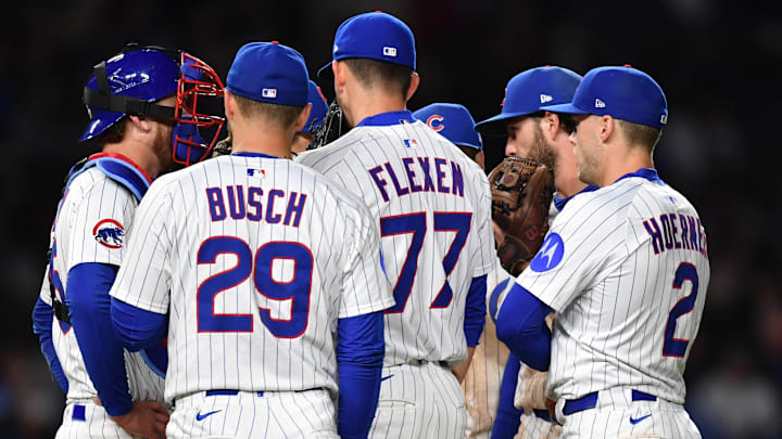 May 27, 2025; Chicago, Illinois, USA; Chicago Cubs players complete a mound visit with pitcher Chris Flexen (77) during the eleventh inning against the Colorado Rockies at Wrigley Field. Mandatory Credit: Patrick Gorski-Imagn Images