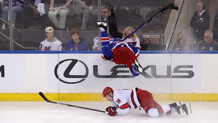 May 7, 2024; New York, New York, USA; New York Rangers defenseman Jacob Trouba (8) goes head first into the boards over Carolina Hurricanes center Martin Necas (88) during the first overtime of game two of the second round of the 2024 Stanley Cup Playoffs at Madison Square Garden. Mandatory Credit: Brad Penner-USA TODAY Sports