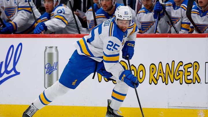 Apr 5, 2026; Denver, Colorado, USA; St. Louis Blues right wing Jordan Kyrou (25) controls the puck in the third period against the Colorado Avalanche at Ball Arena. 