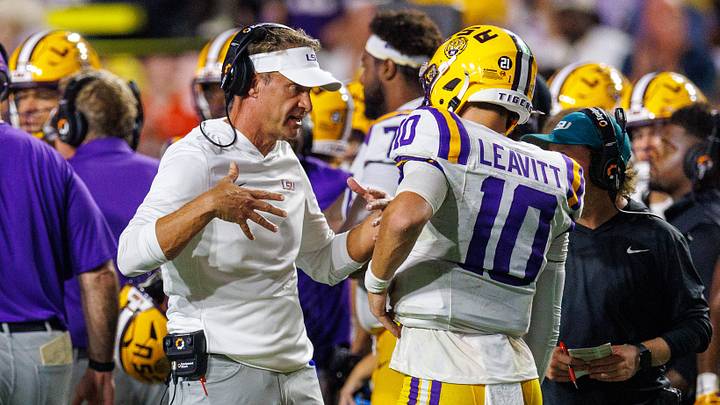 Sep 5, 2026; Baton Rouge, Louisiana, USA; LSU Tigers head coach Lane Kiffin talks to quarterback Sam Leavitt (10) against Clemson Tigers during the first half at Tiger Stadium. Mandatory Credit: Stephen Lew-Imagn Images Sep 5, 2026; Baton Rouge, Louisiana, USA; LSU Tigers head coach Lane Kiffin talks to quarterback Sam Leavitt (10) against Clemson Tigers during the first half at Tiger Stadium. Mandatory Credit: Stephen Lew-Imagn Images