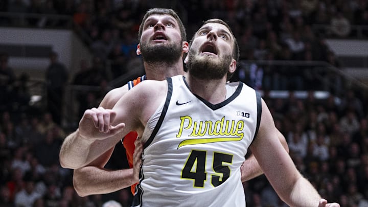 Purdue Boilermakers center Oscar Cluff and Illinois Fighting Illini center Tomislav Ivisic.