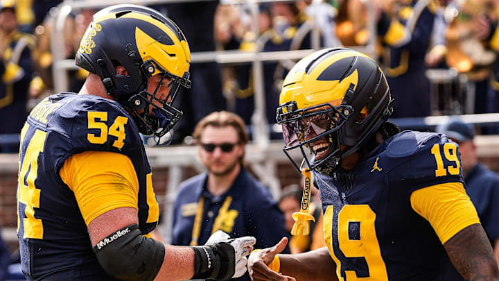 Michigan quarterback Bryce Underwood celebrates a touchdown against Central Michigan with offensive lineman Andrew Sprague during the second half at Michigan Stadium in Ann Arbor.