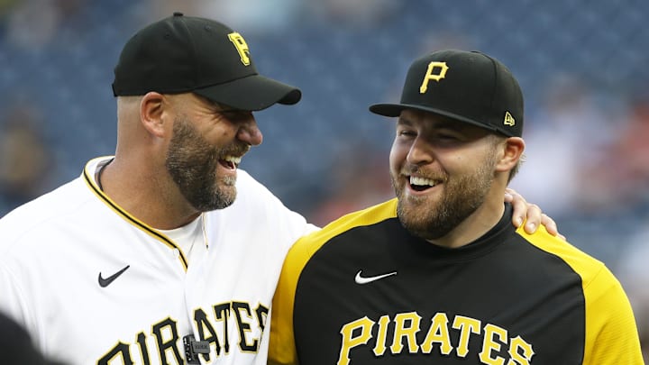 Jul 29, 2022; Pittsburgh, Pennsylvania, USA;  Pittsburgh Steelers former quarterback Ben Roethlisberger (left) and Pirates relief pitcher David Bednar (51) share a laugh after a ceremonial first pitch prior to the Pittsburgh Pirates hosting the Philadelphia Phillies at PNC Park. Mandatory Credit: Charles LeClaire-Imagn Images