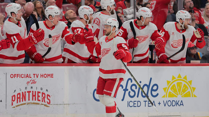 Apr 10, 2025; Sunrise, Florida, USA; Detroit Red Wings right wing Alex DeBrincat (93) celebrates with teammates after scoring against the Florida Panthers during the first period at Amerant Bank Arena. Mandatory Credit: Sam Navarro-Imagn Images