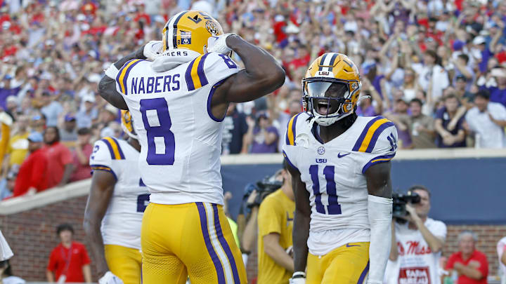 Sep 30, 2023; Oxford, Mississippi, USA; LSU Tigers wide receiver Brian Thomas Jr. (11) reacts with LSU Tigers wide receiver Malik Nabers (8) after a touchdown during the first half at Vaught-Hemingway Stadium. Mandatory Credit: Petre Thomas-Imagn Images