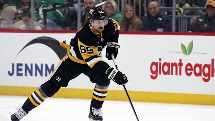Mar 17, 2024; Pittsburgh, Pennsylvania, USA;  Pittsburgh Penguins defenseman Erik Karlsson (65) skates up ice with the puck against the Detroit Red Wings during the first period at PPG Paints Arena. Mandatory Credit: Charles LeClaire-Imagn Images