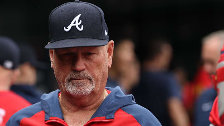 Atlanta Braves manager Brian Snitker stands in the Braves' dugout before the game against the Washington Nationals at Nationals Park.