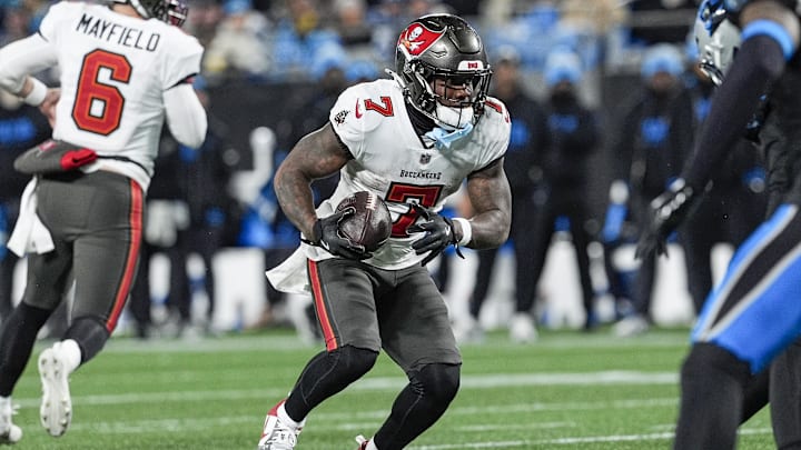 Dec 1, 2024; Charlotte, North Carolina, USA; Tampa Bay Buccaneers running back Bucky Irving (7) runs the ball against the Carolina Panthers during the second half at Bank of America Stadium. Mandatory Credit: Jim Dedmon-Imagn Images