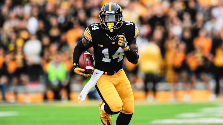 Oct 1, 2016; Iowa City, IA, USA; Iowa Hawkeyes defensive back Desmond King (14) returns a punt against the Northwestern Wildcats during the first quarter at Kinnick Stadium. Mandatory Credit: Jeffrey Becker-Imagn Images