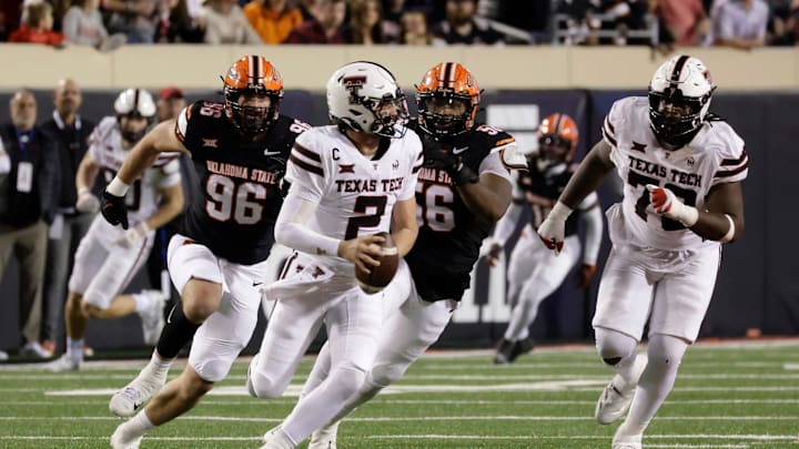 Texas Tech's Behren Morton runs the ball against Oklahoma State's Kody Walterscheid and Xavier Ross while Texas Tech's Sterling Porcher looks on during an NCAA football game on Saturday, Nov. 23, 2024, in Stillwater, Okla.