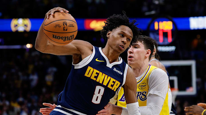 Jan 20, 2026; Denver, Colorado, USA; Denver Nuggets guard Peyton Watson (8) controls the ball under pressure from Los Angeles Lakers forward Jake LaRavia (12) in the first quarter at Ball Arena. Mandatory Credit: Isaiah J. Downing-Imagn Images