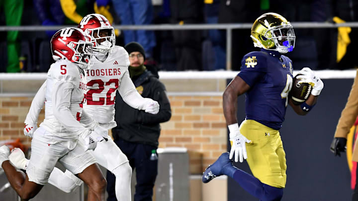 Notre Dame running back Jeremiyah Love (4) runs past Indiana cornerbacks D'Angelo Ponds (5) and Jamari Sharpe (22) at Notre Dame Stadium. 