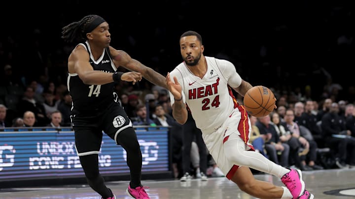 Dec 18, 2025; Brooklyn, New York, USA; Miami Heat guard Norman Powell (24) drives to the basket against Brooklyn Nets guard Terance Mann (14) during the fourth quarter at Barclays Center. Mandatory Credit: Brad Penner-Imagn Images