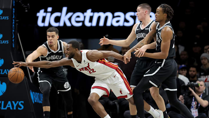 Dec 18, 2025; Brooklyn, New York, USA; Miami Heat forward Andrew Wiggins (22) fights for the ball against Brooklyn Nets forward Michael Porter Jr. (17) and guard Egor Demin (8) and center Nic Claxton (33) during the first quarter at Barclays Center. Mandatory Credit: Brad Penner-Imagn Images Dec 18, 2025; Brooklyn, New York, USA; Miami Heat forward Andrew Wiggins (22) fights for the ball against Brooklyn Nets forward Michael Porter Jr. (17) and guard Egor Demin (8) and center Nic Claxton (33) during the first quarter at Barclays Center. Mandatory Credit: Brad Penner-Imagn Images