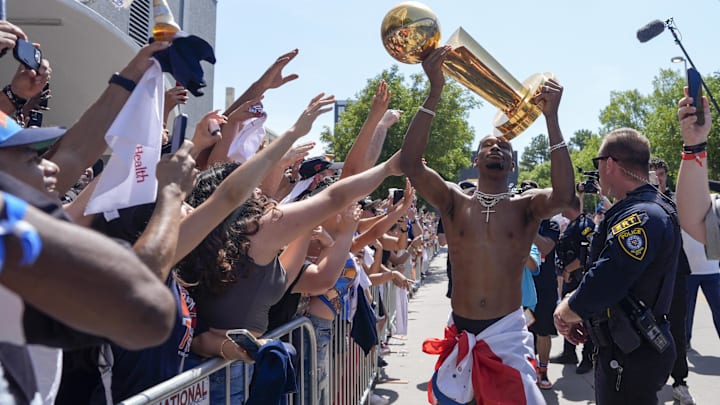 Oklahoma City Thunder guard Shai Gilgeous-Alexander carries the Larry O'Brien trophy as he celebrates with fans as the  Oklahoma City Thunder celebrate their first NBA Finals title win with a champions parade throughout downtown Oklahoma City on Tuesday, June 24, 2025.  Mandatory Credit: Bryan Terry/USA TODAY NETWORK via Imagn Images