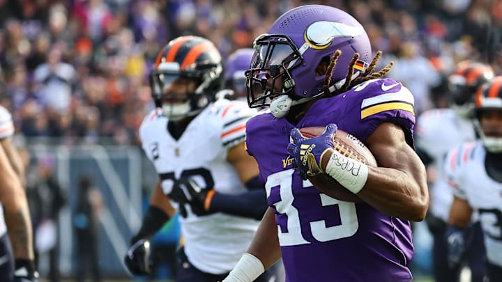 Nov 24, 2024; Chicago, Illinois, USA; Minnesota Vikings running back Aaron Jones (33) rushes the ball against the Chicago Bears during the first quarter at Soldier Field. Mandatory Credit: Mike Dinovo-Imagn Images