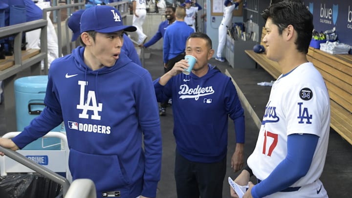 Jun 19, 2025; Los Angeles, California, USA; Los Angeles Dodgers designated hitter Shohei Ohtani (17) laughs with starting pitche Roki Sasaki (11) and trainer Yosuke Nakajima in the dugout prior to the game against the San Diego Padres at Dodger Stadium. Mandatory Credit: Jayne Kamin-Oncea-Imagn Images Jun 19, 2025; Los Angeles, California, USA; Los Angeles Dodgers designated hitter Shohei Ohtani (17) laughs with starting pitche Roki Sasaki (11) and trainer Yosuke Nakajima in the dugout prior to the game against the San Diego Padres at Dodger Stadium. Mandatory Credit: Jayne Kamin-Oncea-Imagn Images