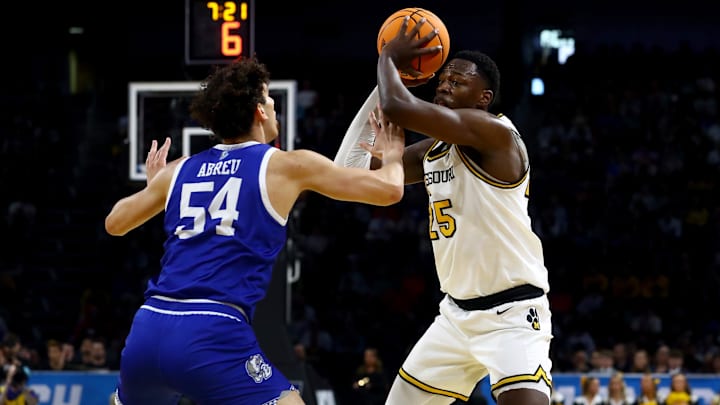 Mar 20, 2025; Wichita, KS, USA; Missouri Tigers guard Mark Mitchell (25) looks to pass against Drake Bulldogs forward Daniel Abreu (54) in the first half of a first round men’s NCAA Tournament game at Intrust Bank Arena. Mandatory Credit: Nick Tre. Smith-Imagn Images