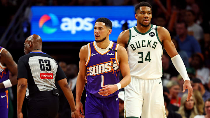 Mar 24, 2025; Phoenix, Arizona, USA; Phoenix Suns guard Devin Booker (1) and Milwaukee Bucks forward Giannis Antetokounmpo (34) during the first quarter at Footprint Center. Mandatory Credit: Mark J. Rebilas-Imagn Images