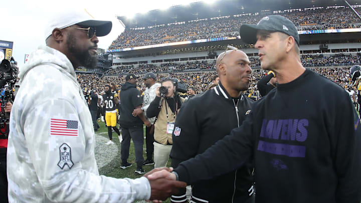 Nov 17, 2024; Pittsburgh, Pennsylvania, USA;  Pittsburgh Steelers head coach Mike Tomlin (left) and Baltimore Ravens head coach John Harbaugh (right) shake hands after the game at Acrisure Stadium. Mandatory Credit: Charles LeClaire-Imagn Images