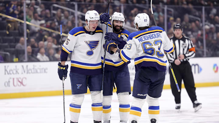 Mar 8, 2025; Los Angeles, California, USA; St. Louis Blues defenseman Nick Leddy (4) celebrates with defenseman Tyler Tucker (75) and left wing Jake Neighbours (63) after scoring against the Los Angeles Kings during the third period at Crypto.com Arena. Mandatory Credit: Ryan Sun-Imagn Images