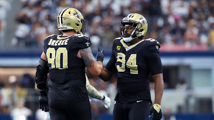 Sep 15, 2024; Arlington, Texas, USA; New Orleans Saints defensive end Cameron Jordan (94) celebrates with New Orleans Saints defensive tackle Bryan Bresee (90) during the second half against the Dallas Cowboys at AT&T Stadium. Mandatory Credit: Kevin Jairaj-Imagn Images