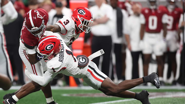 Dec 6, 2025; Atlanta, GA, USA; Alabama Crimson Tide wide receiver Lotzeir Brooks (17) runs after making a catch as Georgia Bulldogs defensive back Ellis Robinson IV (1) tackles during the first quarter during the 2025 SEC Championship game at Mercedes-Benz Stadium. Mandatory Credit: Brett Davis-Imagn Images Dec 6, 2025; Atlanta, GA, USA; Alabama Crimson Tide wide receiver Lotzeir Brooks (17) runs after making a catch as Georgia Bulldogs defensive back Ellis Robinson IV (1) tackles during the first quarter during the 2025 SEC Championship game at Mercedes-Benz Stadium. Mandatory Credit: Brett Davis-Imagn Images