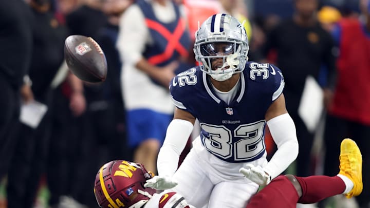 Jan 5, 2025; Arlington, Texas, USA; Dallas Cowboys cornerback Troy Pride Jr. (32) defends a pass against Washington Commanders wide receiver Olamide Zaccheaus (14) during the second quarter at AT&T Stadium.