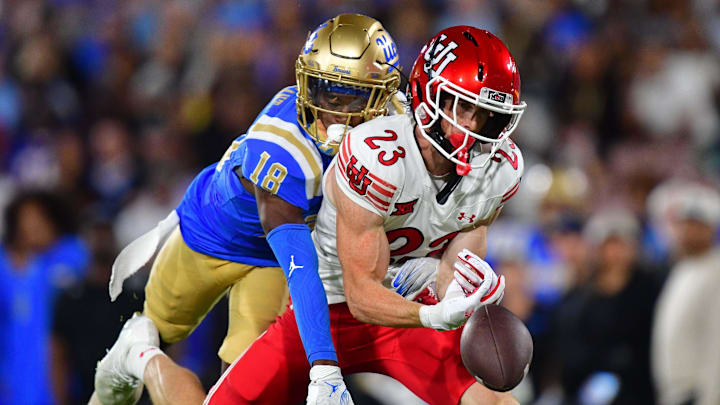 Aug 30, 2025; Pasadena, California, USA; Utah Utes safety Jackson Bennee (23) on offense misses catching a pass against the defense of UCLA Bruins defensive back Jadyn Marshall (18) during the first half at Rose Bowl. Mandatory Credit: Gary A. Vasquez-Imagn Images