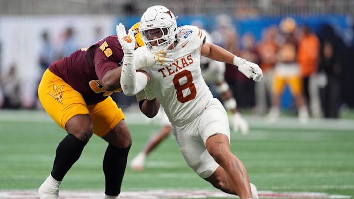 Jan 1, 2025; Atlanta, GA, USA; Texas Longhorns linebacker Trey Moore (8) runs around Arizona State Sun Devils offensive lineman Max Iheanachor (58) during the first half of the Peach Bowl at Mercedes-Benz Stadium. Mandatory Credit: Dale Zanine-Imagn Images