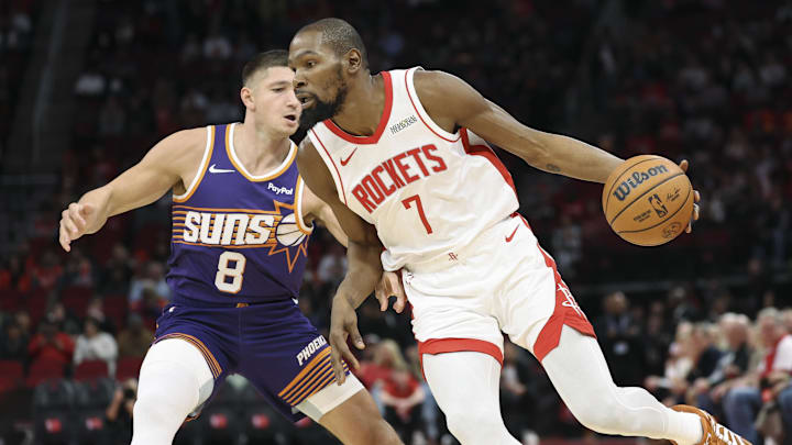 Dec 5, 2025; Houston, Texas, USA; Houston Rockets forward Kevin Durant (7) attempts to dribble past Phoenix Suns guard Grayson Allen (8) during the first quarter at Toyota Center. Mandatory Credit: Troy Taormina-Imagn Images