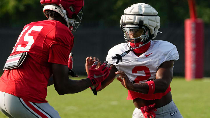 Aug 8, 2024; Columbus, Ohio, USA; Ohio State Buckeyes safety Caleb Downs (2) lines up across from tight end Jelani Thurman (15) during football practice at the Woody Hayes Athletic Complex.
