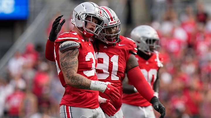 Aug 31, 2024; Columbus, OH, USA; Ohio State Buckeyes defensive end Jack Sawyer (33) gets a hug from defensive tackle Tyleik Williams (91) during the first half of the NCAA football game against the Akron Zips at Ohio Stadium.
