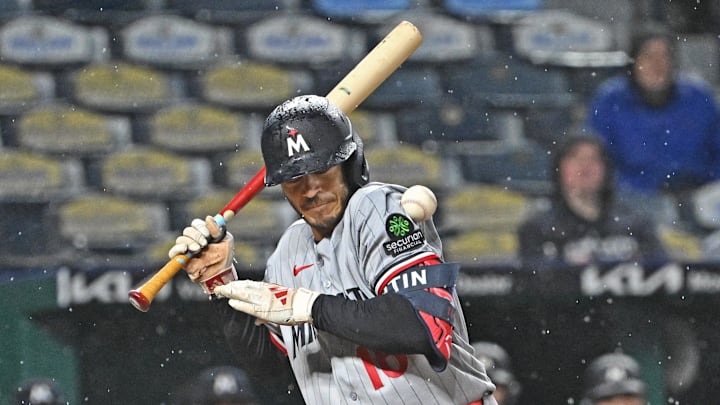Apr 1, 2026; Kansas City, Missouri, USA;  Minnesota Twins left fielder Austin Martin (16) gets hit with a pitch, driving in a run with the bases loaded in the eighth inning against the Kansas City Royals at Kauffman Stadium. Mandatory Credit: Peter Aiken-Imagn Images