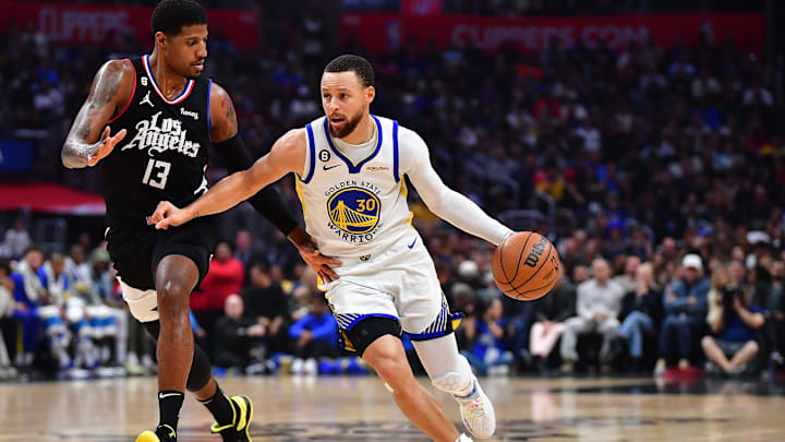Mar 15, 2023; Los Angeles, California, USA; Golden State Warriors guard Stephen Curry (30) moves the ball against Los Angeles Clippers forward Paul George (13) during the first half at Crypto.com Arena. Mandatory Credit: Gary A. Vasquez-USA TODAY Sports