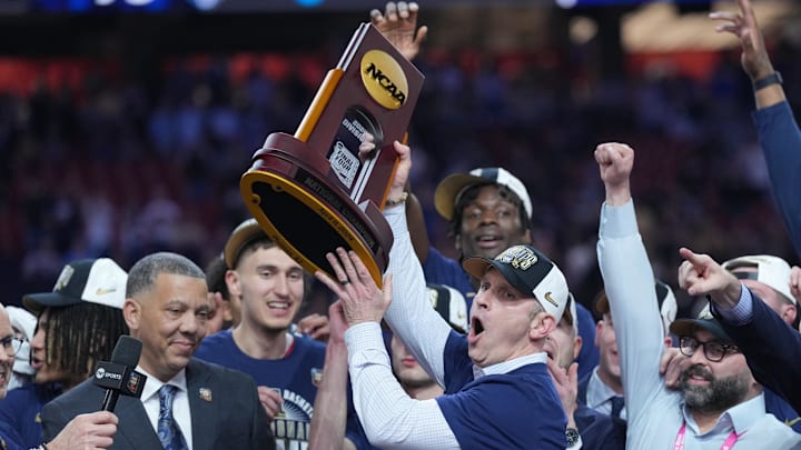 UConn Huskies head coach Dan Hurley hoists the championship trophy