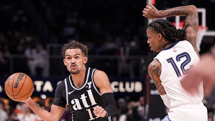Dec 23, 2023; Atlanta, Georgia, USA; Atlanta Hawks guard Trae Young (11) passes against Memphis Grizzlies guard Ja Morant (12) during the first half at State Farm Arena. Mandatory Credit: Dale Zanine-Imagn Images