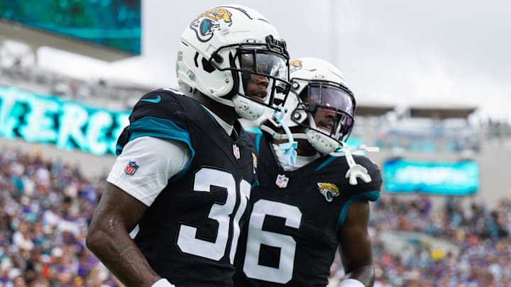 Nov 10, 2024; Jacksonville, Florida, USA; Jacksonville Jaguars cornerback Montaric Brown (30) and safety Darnell Savage (6) celebrates an interception against the Minnesota Vikings in the second quarter at EverBank Stadium. Mandatory Credit: Jeremy Reper-Imagn Images