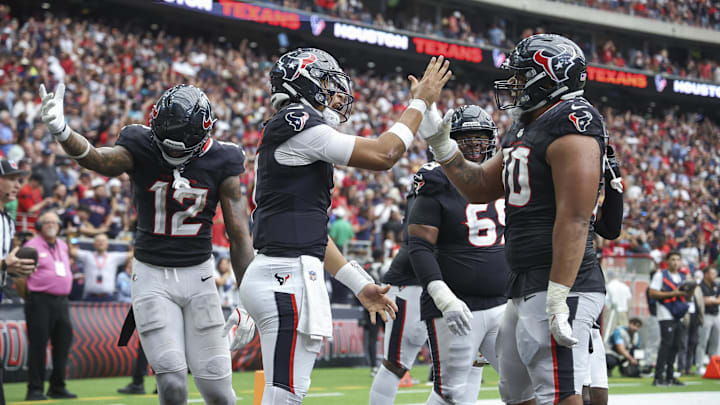 Sep 29, 2024; Houston, Texas, USA; Houston Texans quarterback C.J. Stroud (7) celebrates with center Juice Scruggs (70) after a Texans touchdown during the fourth quarter against the Jacksonville Jaguars at NRG Stadium. Mandatory Credit: Troy Taormina-Imagn Images