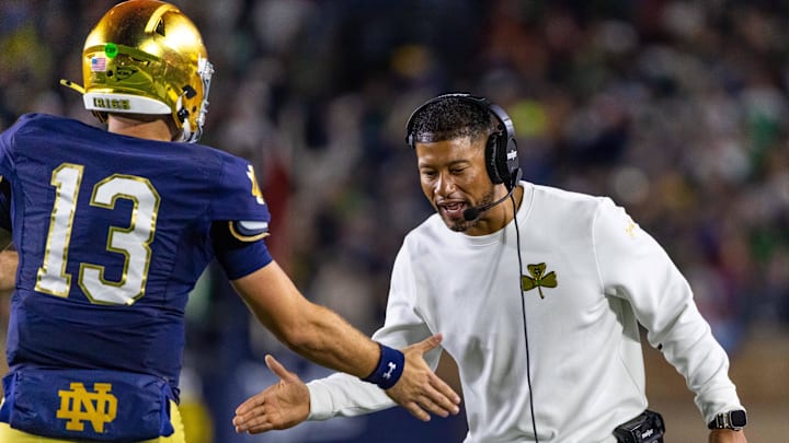 Oct 18, 2025; South Bend, Indiana, USA; Notre Dame Fighting Irish head coach Marcus Freeman celebrates with quarterback CJ Carr (13) during the first half against the Southern California Trojans at Notre Dame Stadium. Oct 18, 2025; South Bend, Indiana, USA; Notre Dame Fighting Irish head coach Marcus Freeman celebrates with quarterback CJ Carr (13) during the first half against the Southern California Trojans at Notre Dame Stadium.