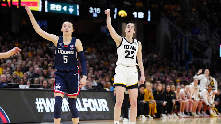 Apr 5, 2024; Cleveland, OH, USA; Iowa Hawkeyes guard Caitlin Clark (22) and Connecticut Huskies guard Paige Bueckers (5) react in the second quarter in the semifinals of the Final Four of the womens 2024 NCAA Tournament at Rocket Mortgage FieldHouse. Mandatory Credit: Kirby Lee-Imagn Images
