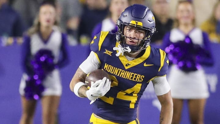 Oct 19, 2024; Morgantown, West Virginia, USA; West Virginia Mountaineers wide receiver Rodney Gallagher III (24) runs after a catch during the second quarter against the Kansas State Wildcats at Mountaineer Field at Milan Puskar Stadium. Mandatory Credit: Ben Queen-Imagn Images