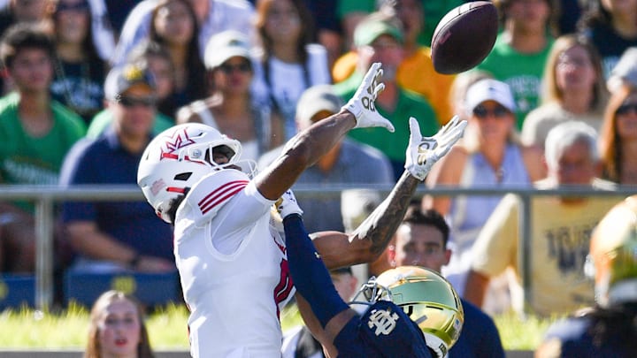 Sep 21, 2024; South Bend, Indiana, USA; Notre Dame Fighting Irish cornerback Jaden Mickey (7) breaks up a pass intended for Miami Redhawks wide receiver Reggie Virgil (0) in the second quarter at Notre Dame Stadium. Mandatory Credit: Matt Cashore-Imagn Images