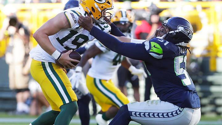 Seattle Seahawks linebacker Jared Ivey (51) tries to tackle Green Bay Packers quarterback Taylor Elgersma (19). Seattle Seahawks linebacker Jared Ivey (51) tries to tackle Green Bay Packers quarterback Taylor Elgersma (19).